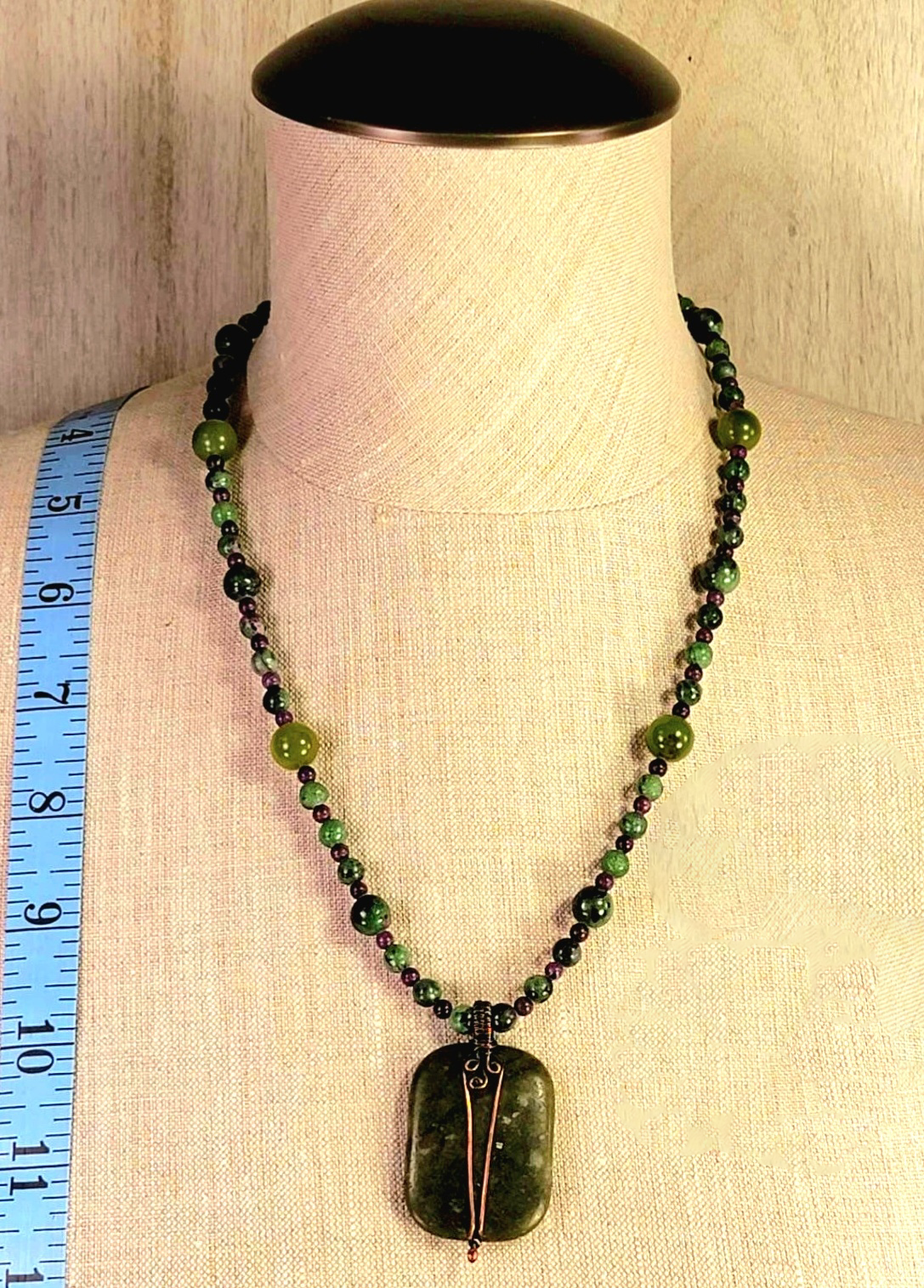 Jade pendant. Surrounded by the rich purples of Sugilite the forest greens of Aventurine & Ruby red of Zoisite.