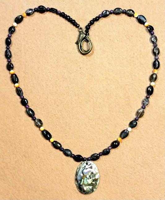 Opalescent Mother of Pearl pendant: Highlighted by the deep rich color of Sugilite and the flashing Chatoyance in Labradorite
