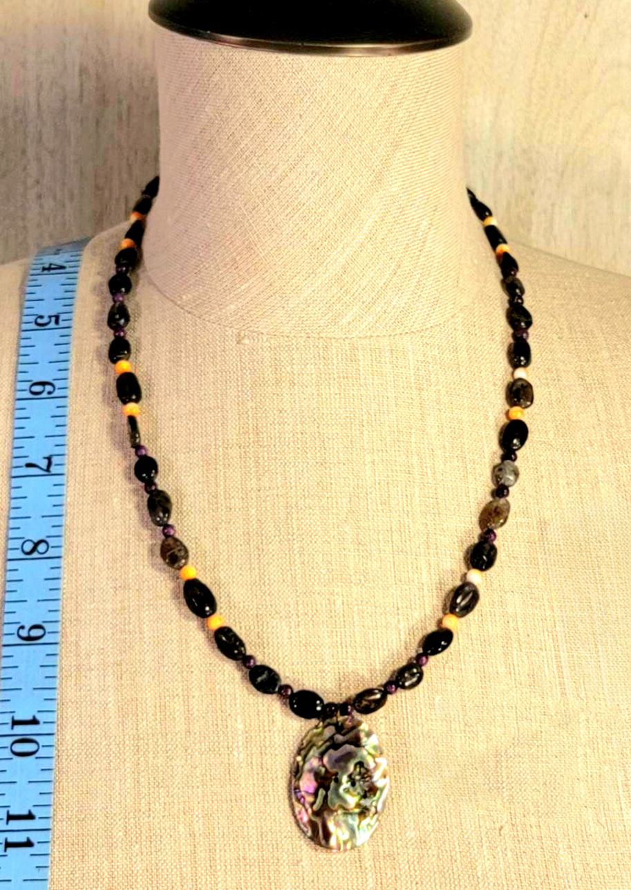 Opalescent Mother of Pearl pendant: Highlighted by the deep rich color of Sugilite and the flashing Chatoyance in Labradorite