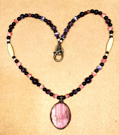 Rhodochrosite Cabochon:  Black Tourmaline, Chevron Amethyst, Rhodalite, Amethyst, Bone & Seed            & seed