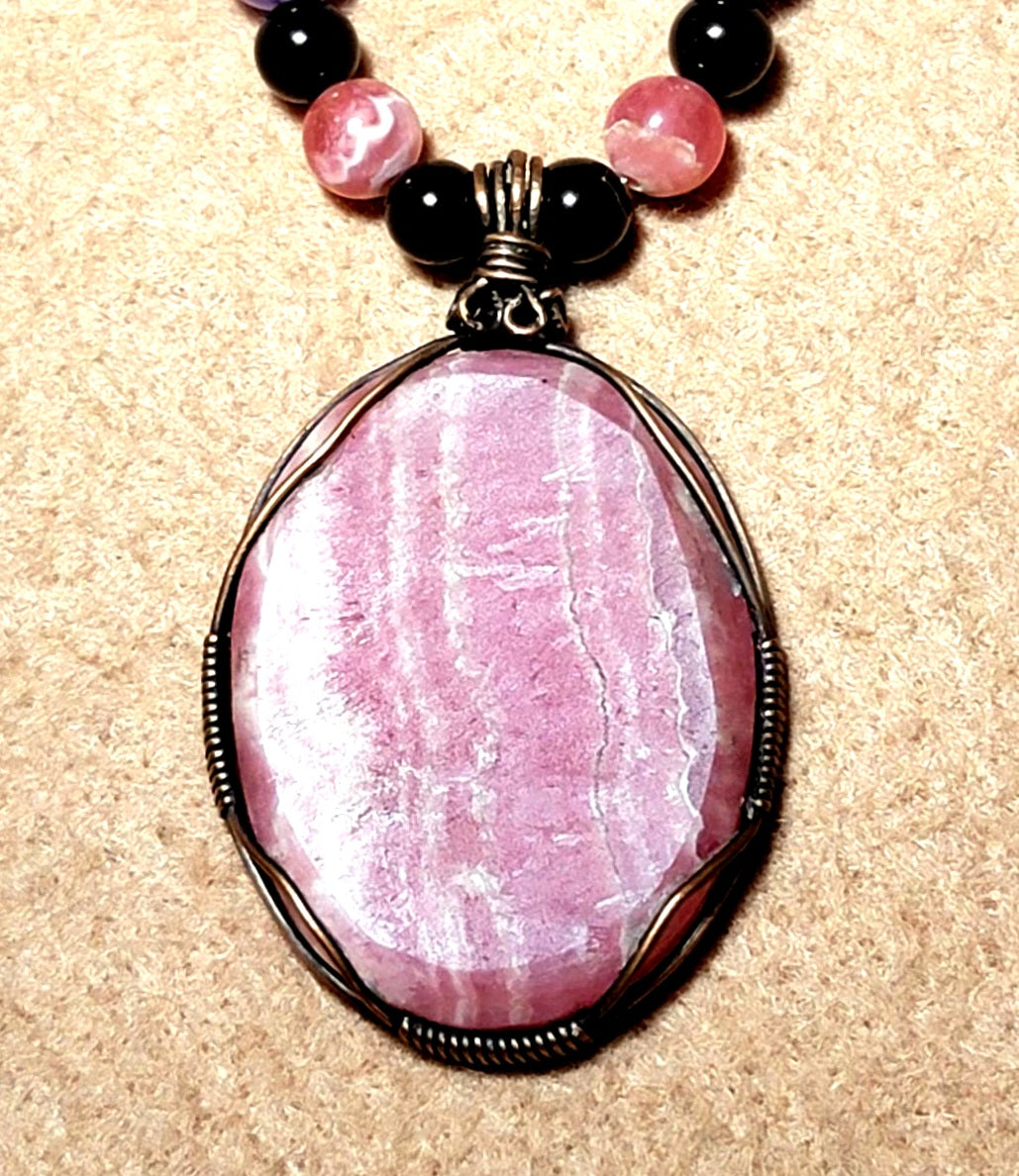 Rhodochrosite Cabochon:  Black Tourmaline, Chevron Amethyst, Rhodalite, Amethyst, Bone & Seed            & seed