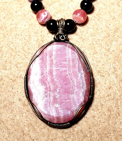 Rhodochrosite Cabochon:  Black Tourmaline, Chevron Amethyst, Rhodalite, Amethyst, Bone & Seed            & seed