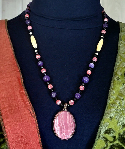 Rhodochrosite Cabochon:  Black Tourmaline, Chevron Amethyst, Rhodalite, Amethyst, Bone & Seed            & seed