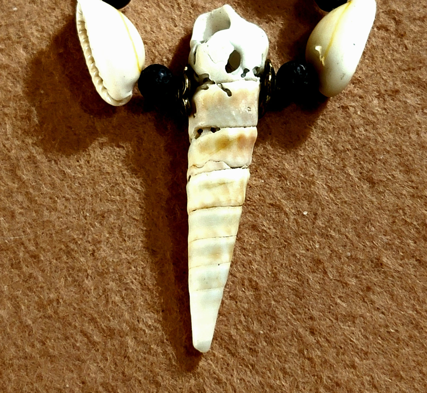 Shell Pendant:  Kukui Nut, Ox Horn, Shell, Bone & Lava.     Loving the color contrasts Between the brown Kukui and white of the Shells