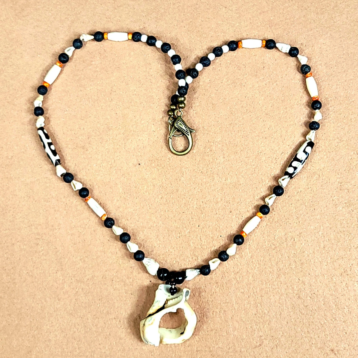 Shell Pendant: Oyster Shell, Bone, Shell & Lava  Elegantly connecting ones heart chakra to the external through the portal center of the shell.